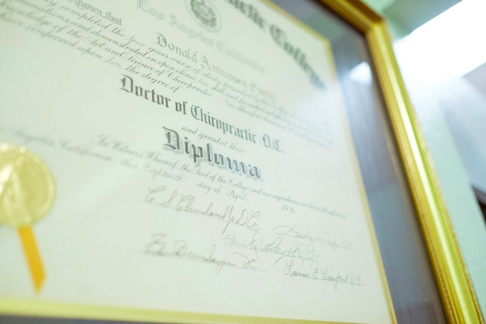 A framed diploma with a gold seal