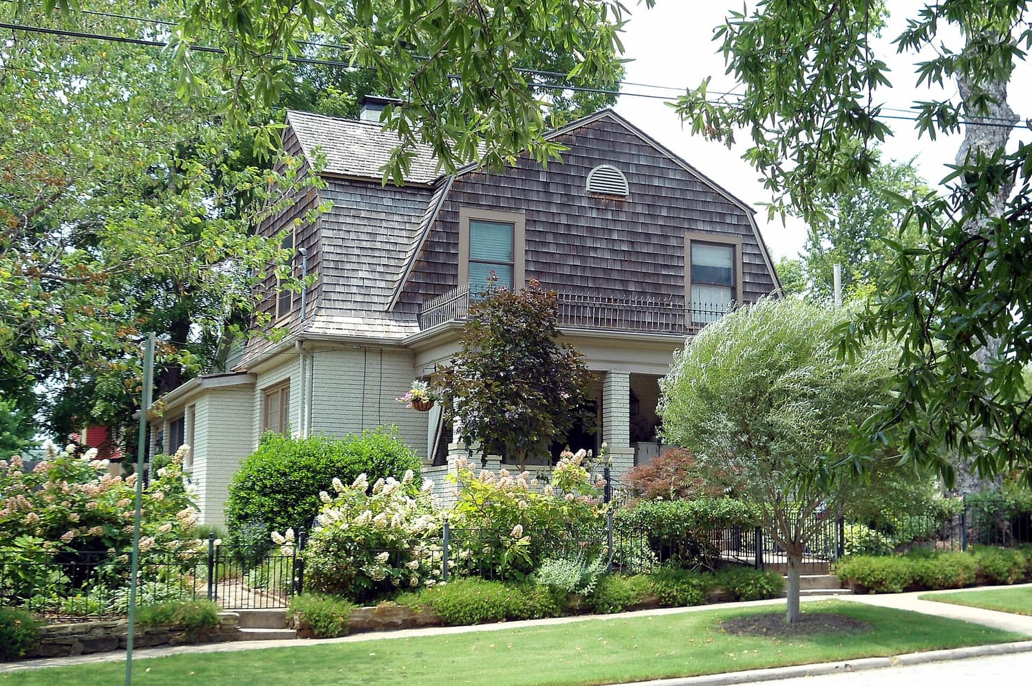 A two-storey house behind a low stone wall on Lafayette Street in the Washington-Willow Historic District of Fayetteville, Arkansas