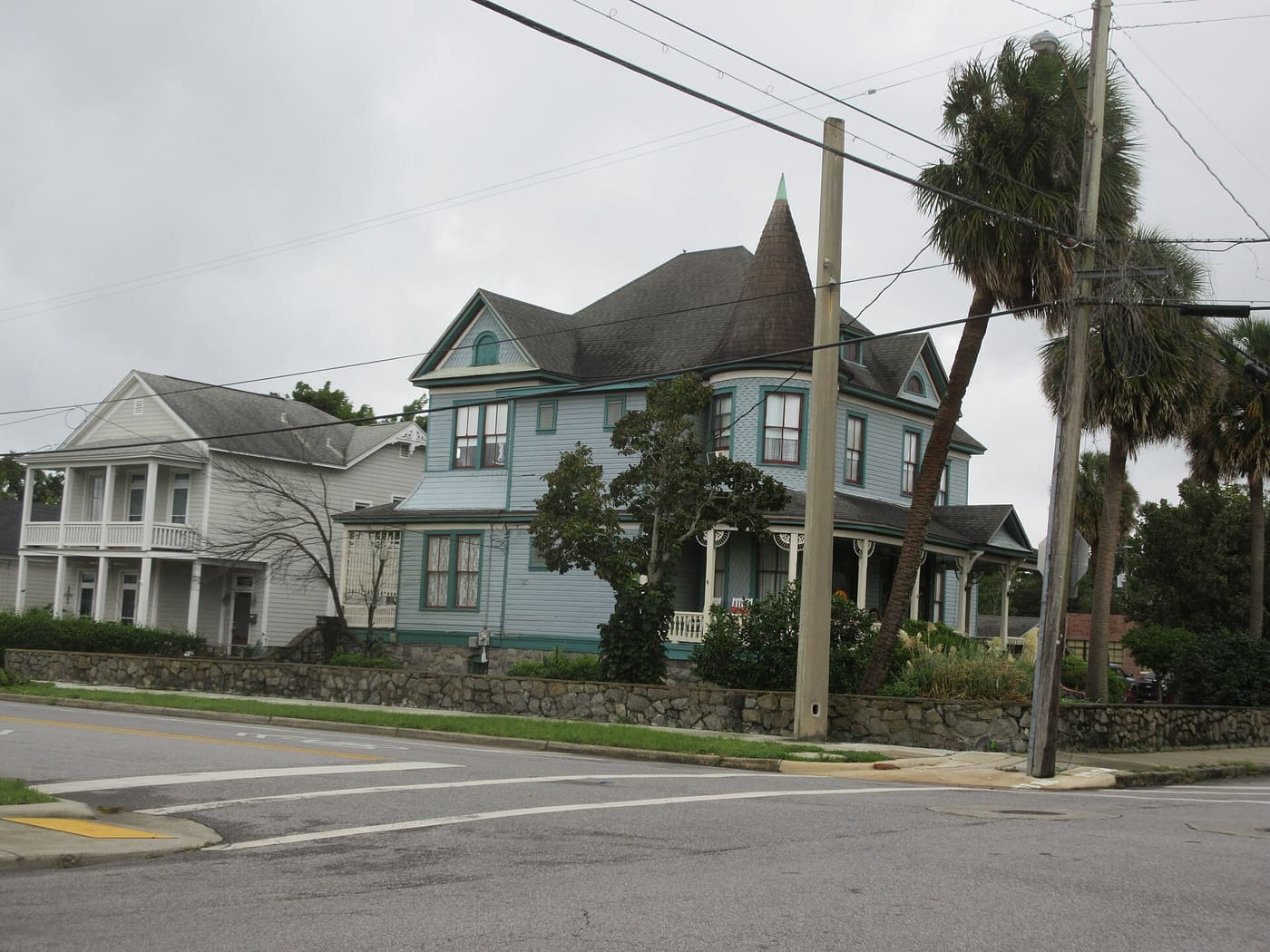 A residential street of houses with porches and mature trees in Pensacola, Florida