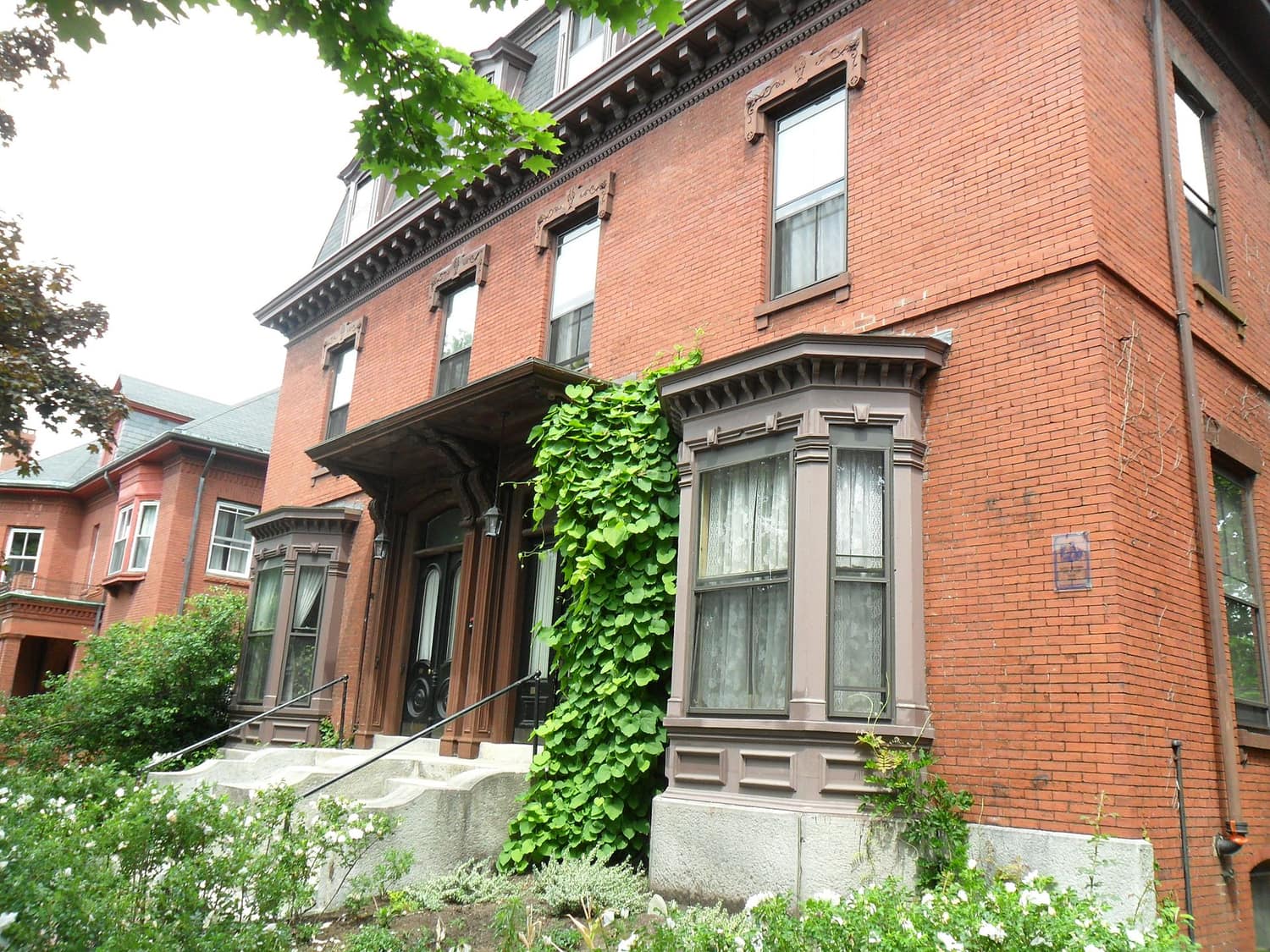 A large Victorian house with a mansard roof in the Deering Street Historic District in Portland, Maine