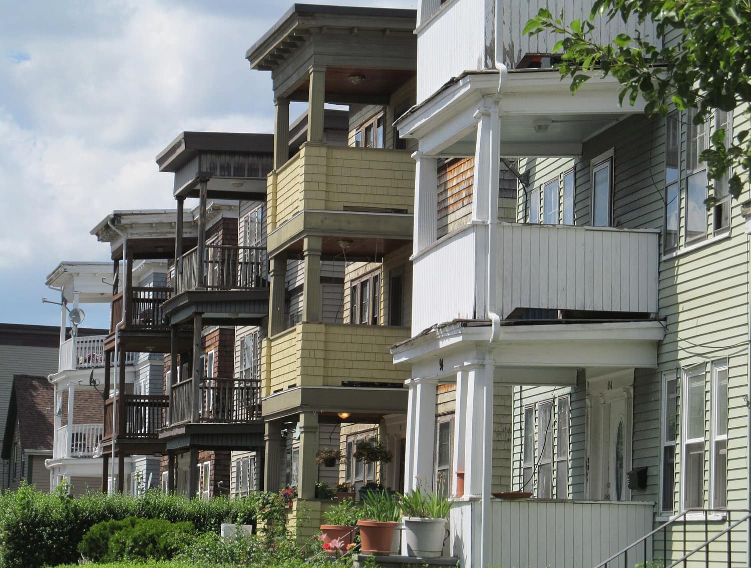 Stacked wooden porches on triple-decker houses along Rosseter Street in Dorchester, Boston